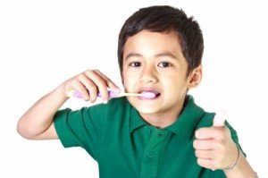 Child happily brushing his teeth
